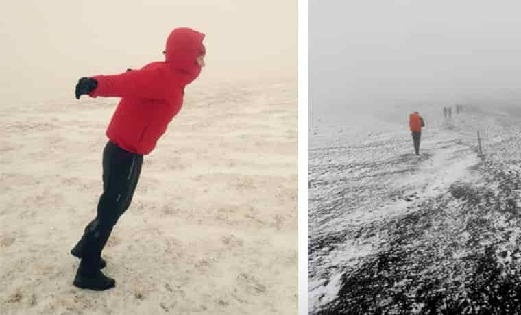 Person winter hiking in windy snow scene
