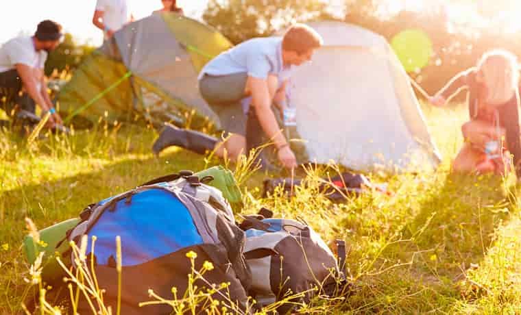 People setting up items on a camping checklist