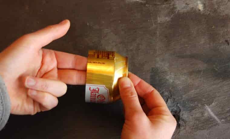 Holding the soda can with two fingers