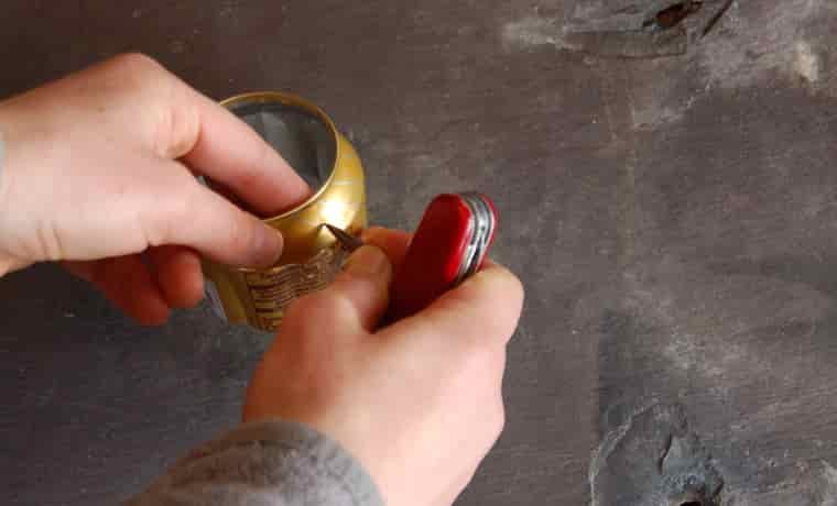 Making a hole in a soda can