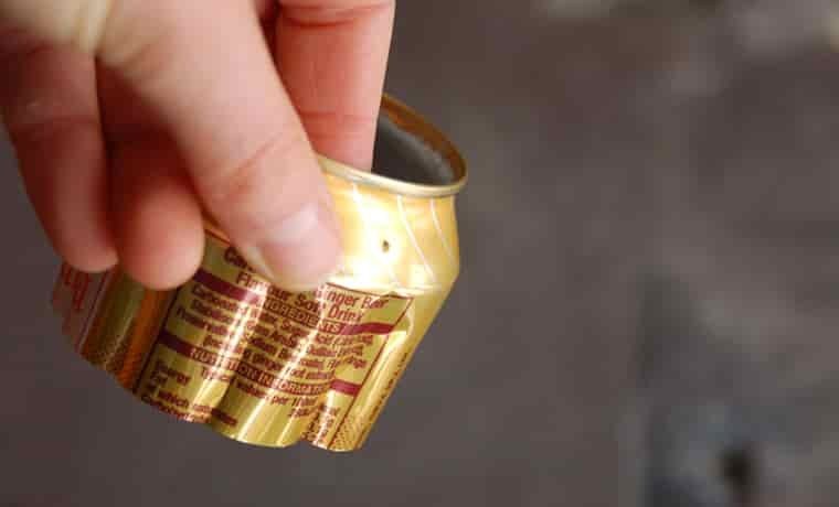 Close up of hole in the side of a soda can
