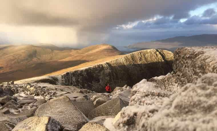 Approaching storm over mountains on a sunrise hike