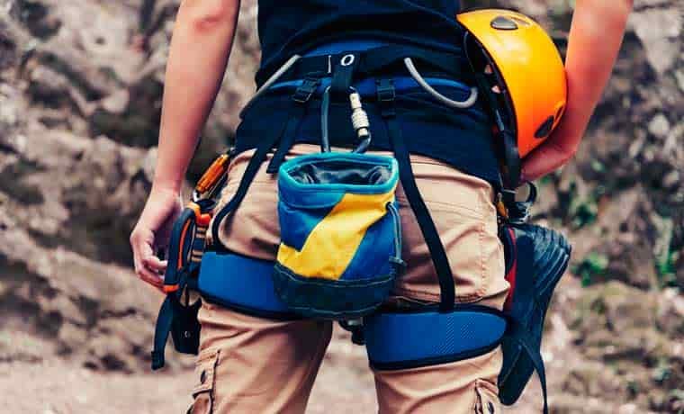 Rock climbing gear hanging from climbing harness