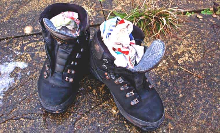 Newspaper in hiking boots