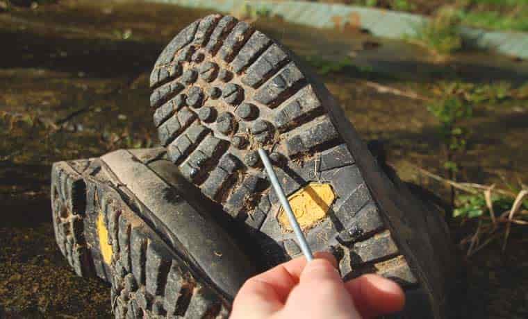 Poking mud from boot soles