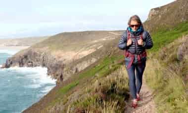 Woman hiking on coast path in leggings