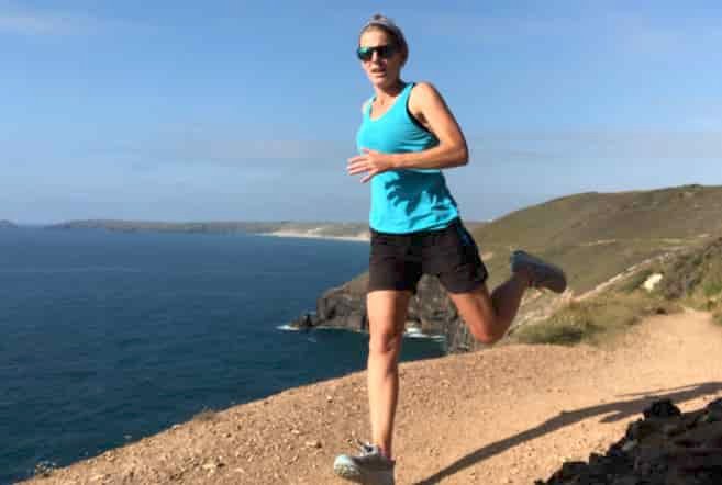 Woman running on coast path