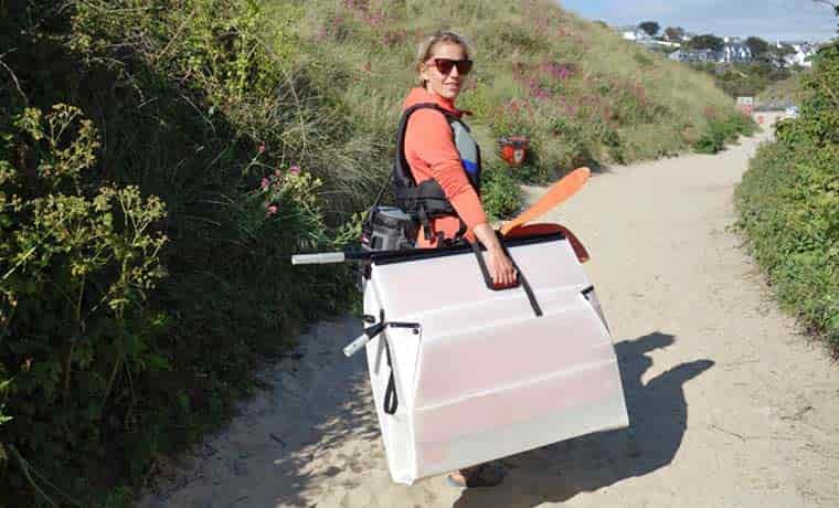Woman carrying origami kayak