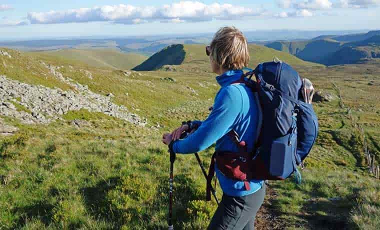 Woman wearing pack in mountains
