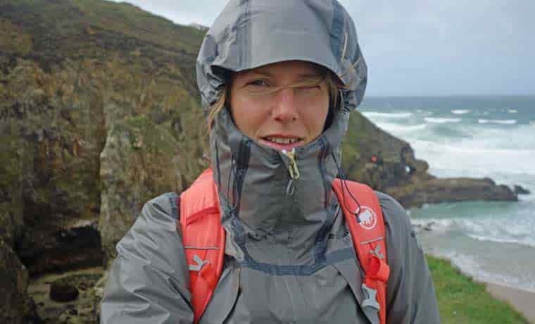 Woman in hood on cliffs
