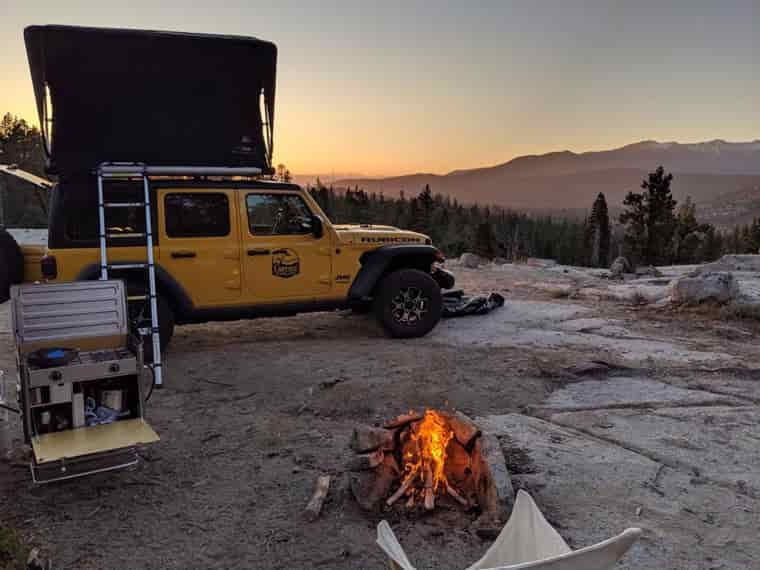 Rooftop tent camping with a fire