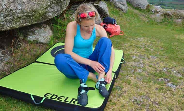 Woman putting climbing shoes on