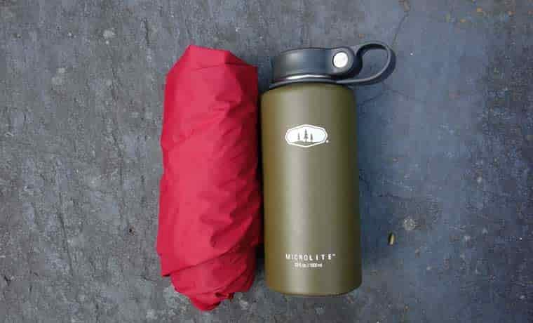Jacket packed next to bottle