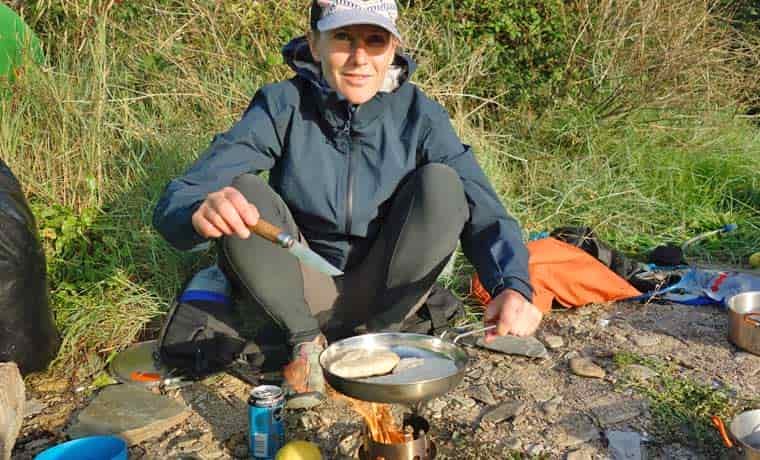Woman cooking on camp stove