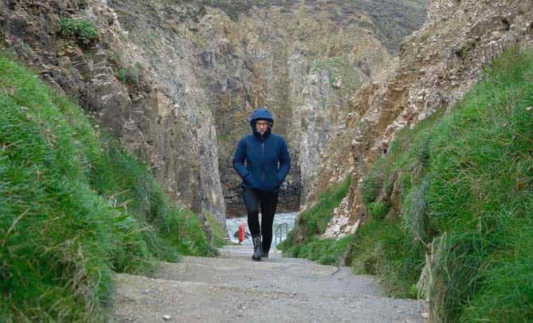 Woman walking up steps in jacket