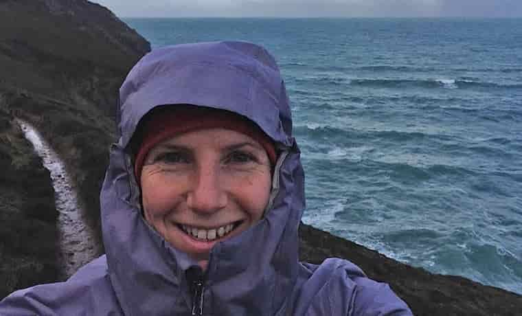 Hooded woman by the sea