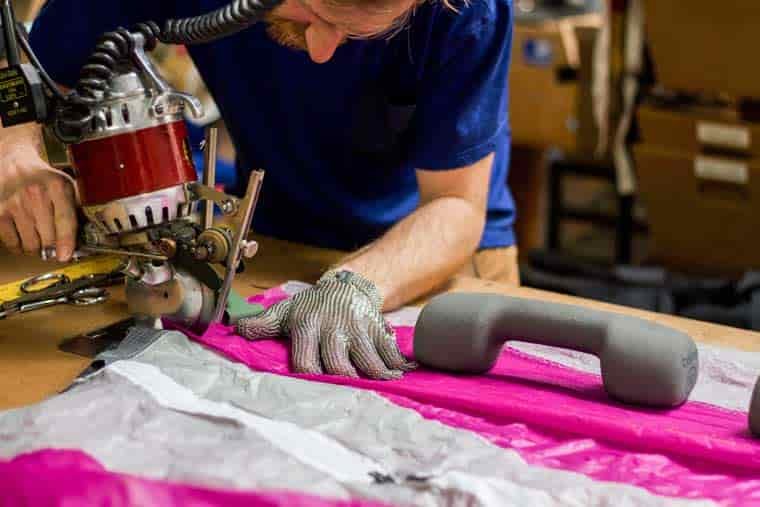 Man sewing upcycled fabric
