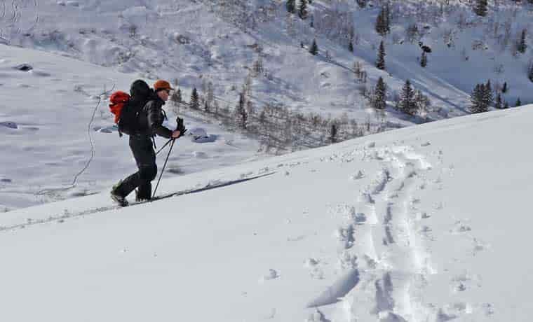 Man splitboarding uphill