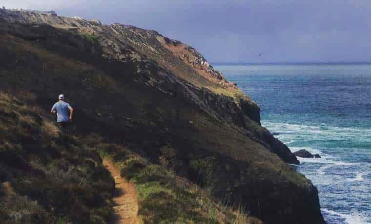 Man running on coast path