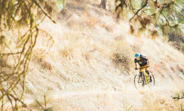 Man mountain biking uphill