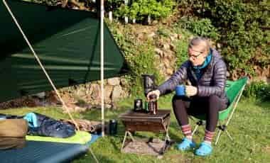 Woman making coffee camping