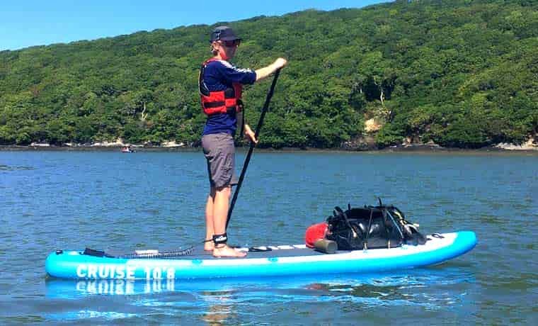 Woman paddle boarding on river