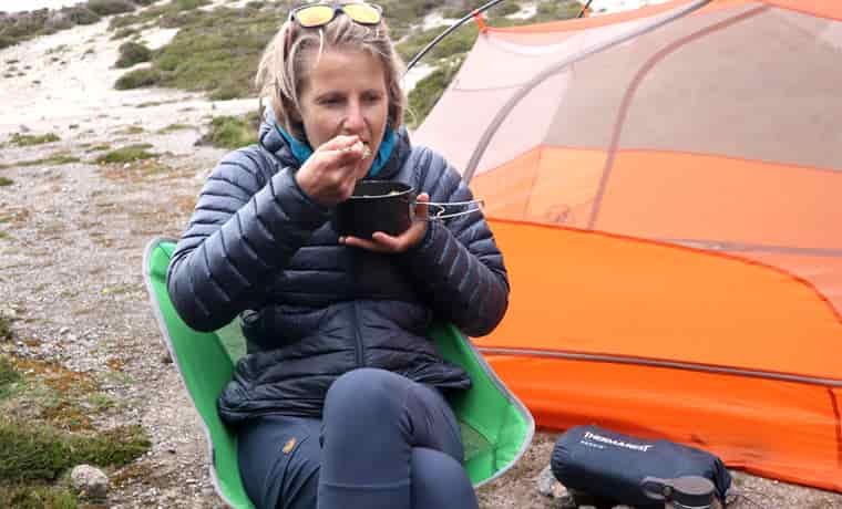 Camper eating vegan backpacking meal