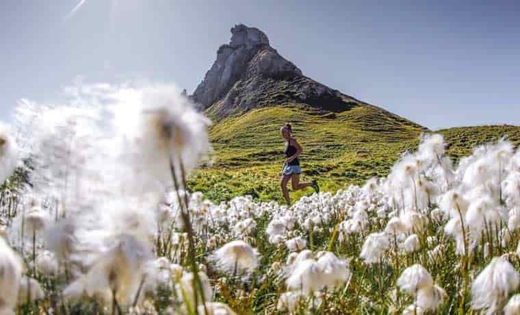Woman running in mountain meadow