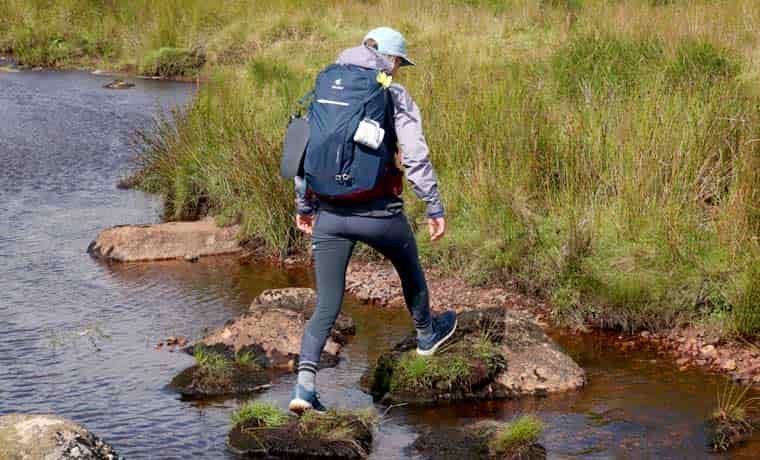 Hiker crossing river