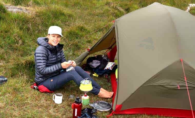 Woman sitting outside of tent
