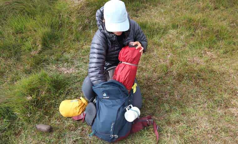 Packing tent into backpack