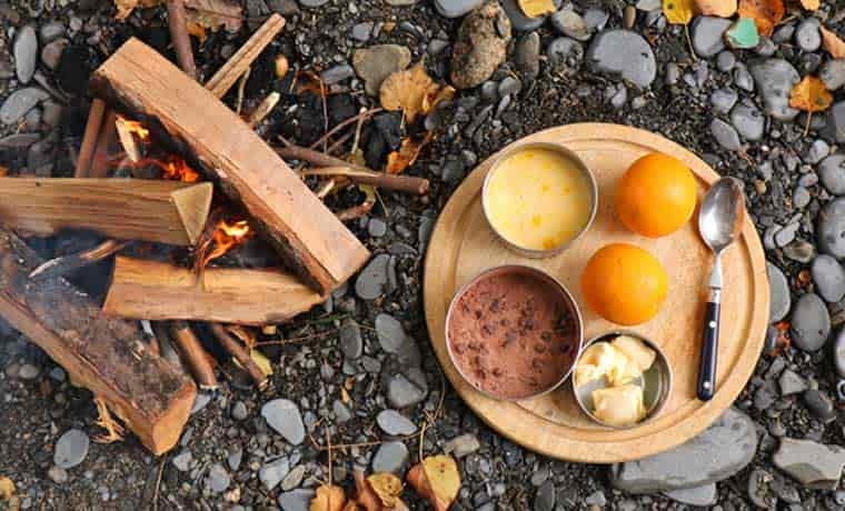 Cake ingredients next to campfire