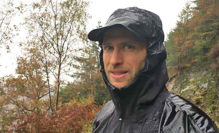 Man with rain jacket hood up