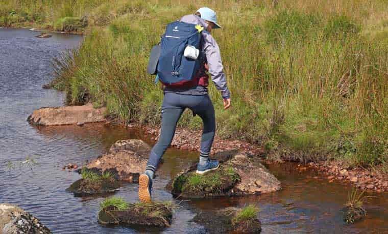 Woman crossing a stream