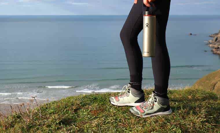 Person standing in hiking boots with water bottle