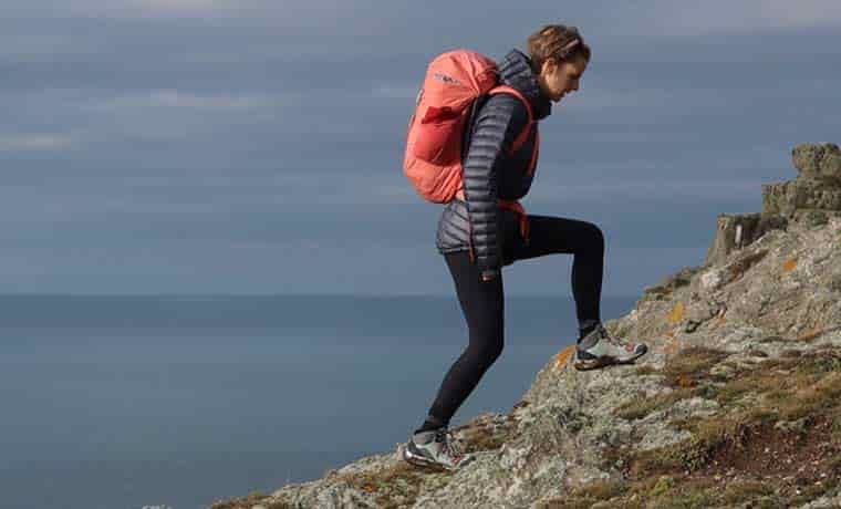 Woman hiking on cliff
