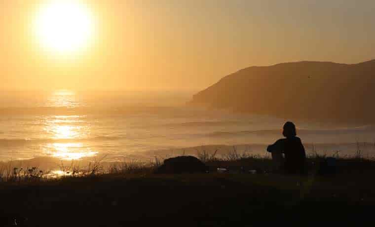 Woman sitting watching waves