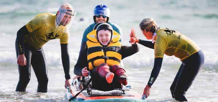 People teaching adaptive surfing