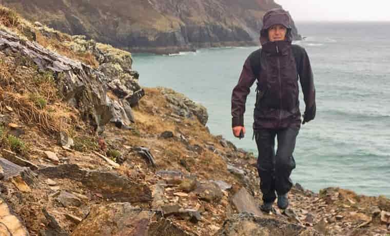 Woman hiking on rocks by the sea
