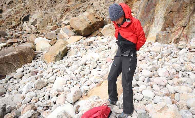 Woman putting waterproof pants on