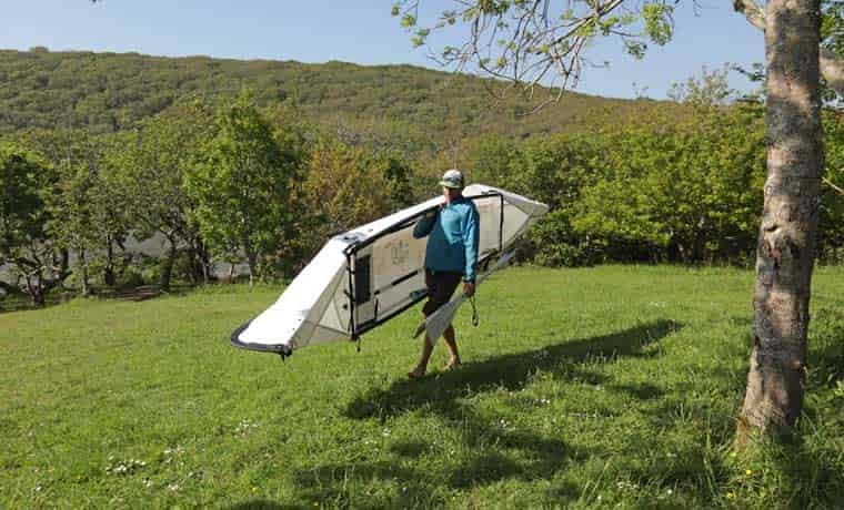 Carrying canoe on shoulder
