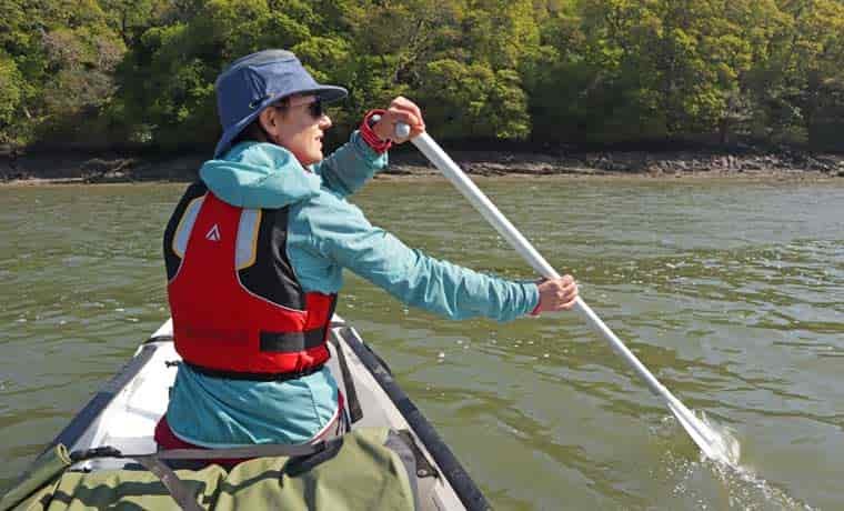 Woman paddling canoe