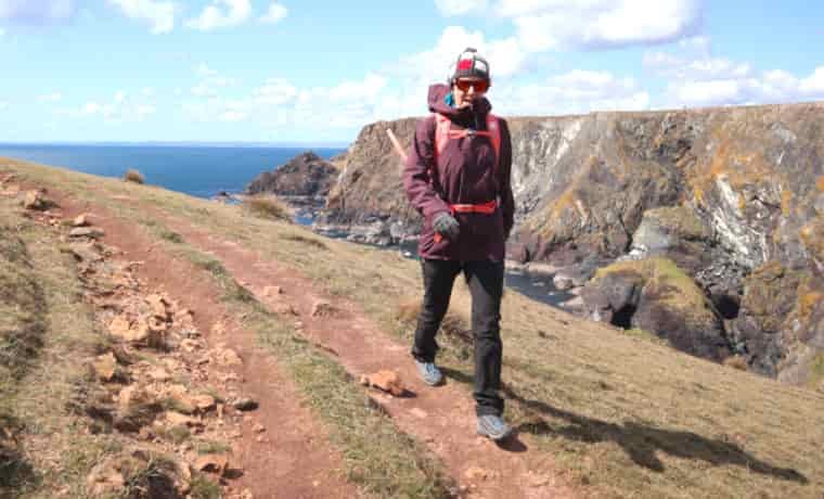 Woman walking on coastal path