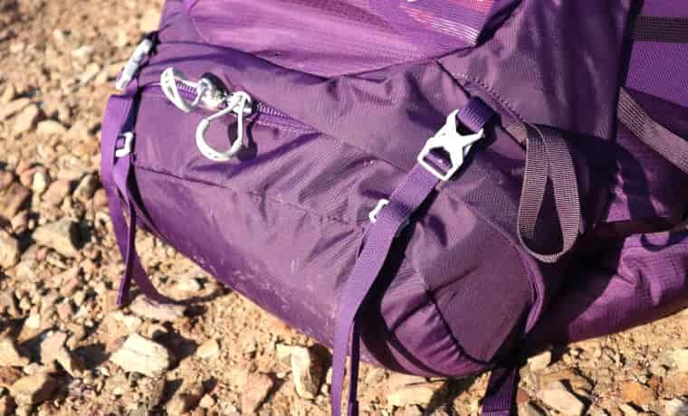 Backpack sleeping bag compartment