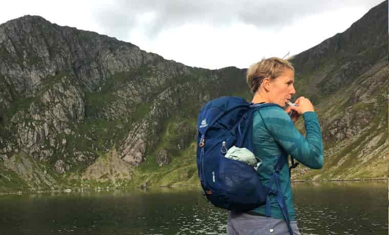 Woman hiking by lake
