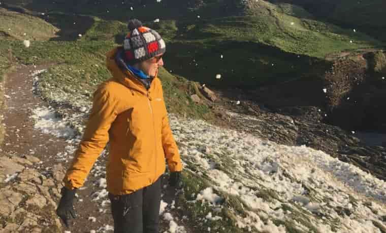 Woman wearing jacket in the hills