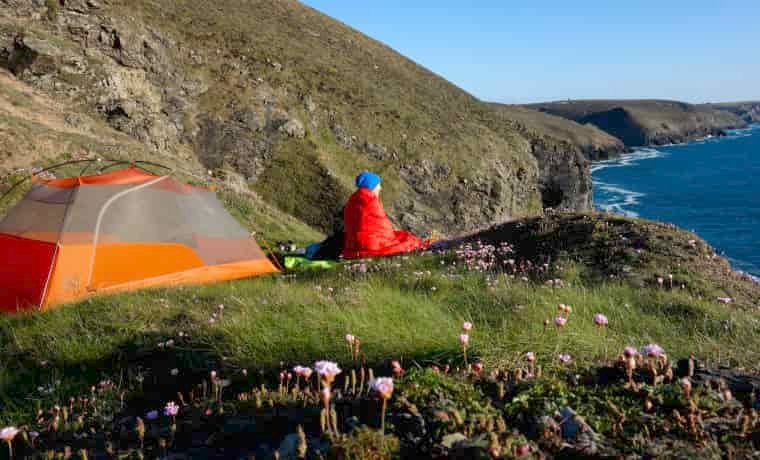Woman camping alone on cliffs
