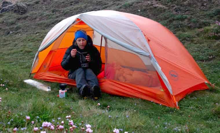 Woman eating camping food alone