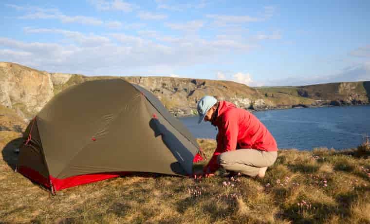Woman putting up a tent