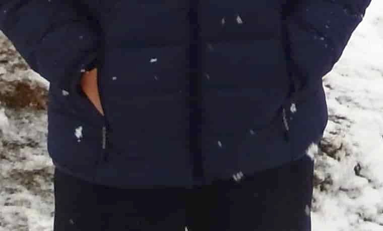 Hands in jacket pockets